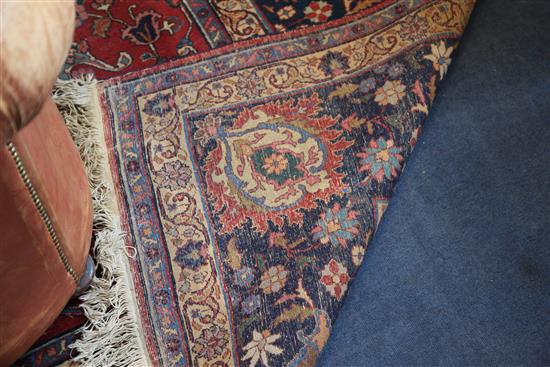 A Kirman red ground carpet, 14ft 1in by 10ft 10in.